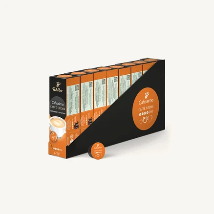 Displejový box s kapslemi Tchibo Cafissimo Caffe Crema, s jednotlivými kapslemi ležícími před boxem.