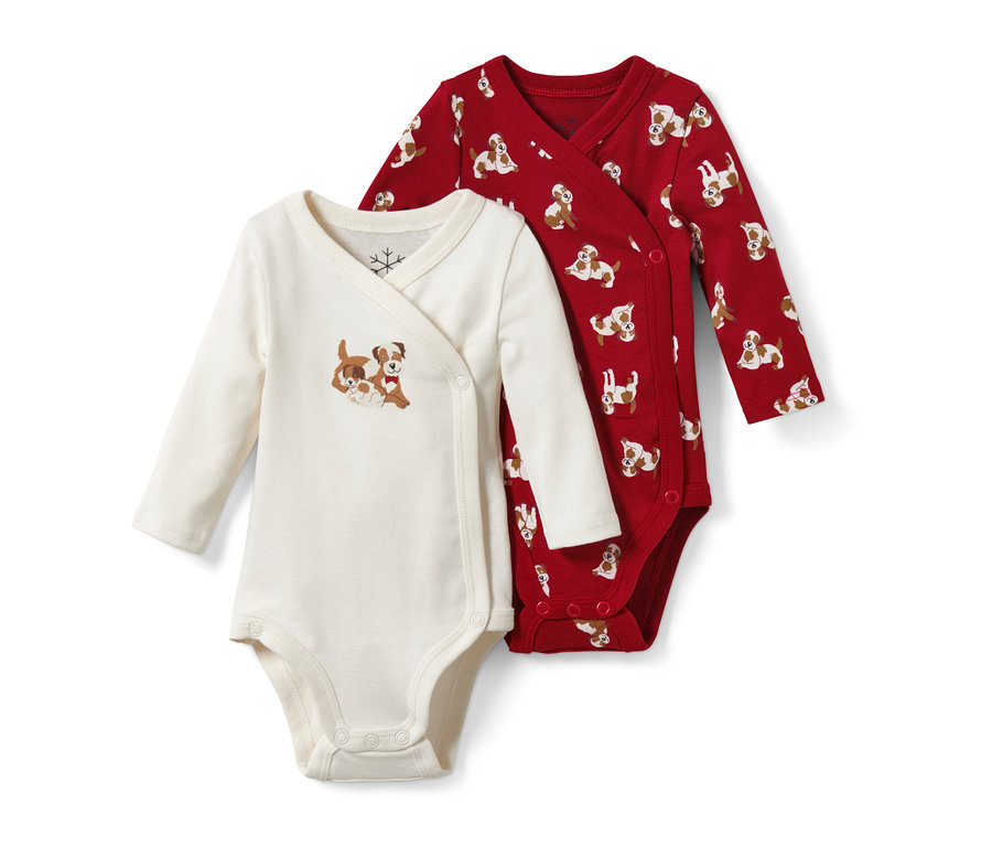 Dvě kojenecká body: jedno krémové s obrázkem psů, druhé červené s potiskem psů.