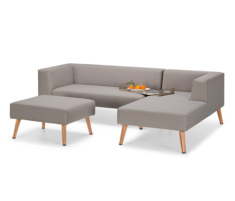 Šedá venkovní pohovka se stoličkou a tácem s ovocem.