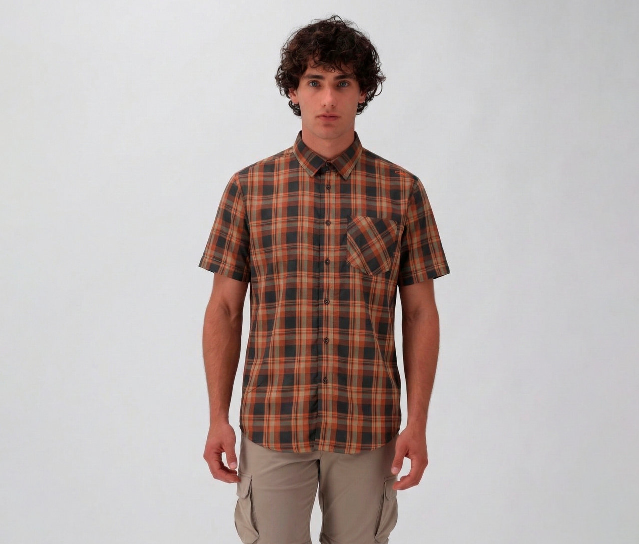 Muž má na sobě pánskou košili s krátkým rukávem CMP s hnědým a šedým kostkovaným vzorem a béžové cargo kalhoty na bílém pozadí.