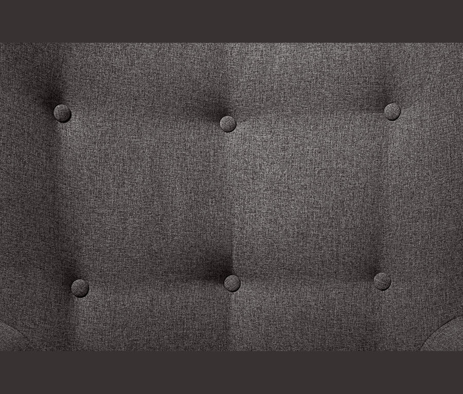Detail látky tmavě šedého křesla s podnožkou a knoflíky.