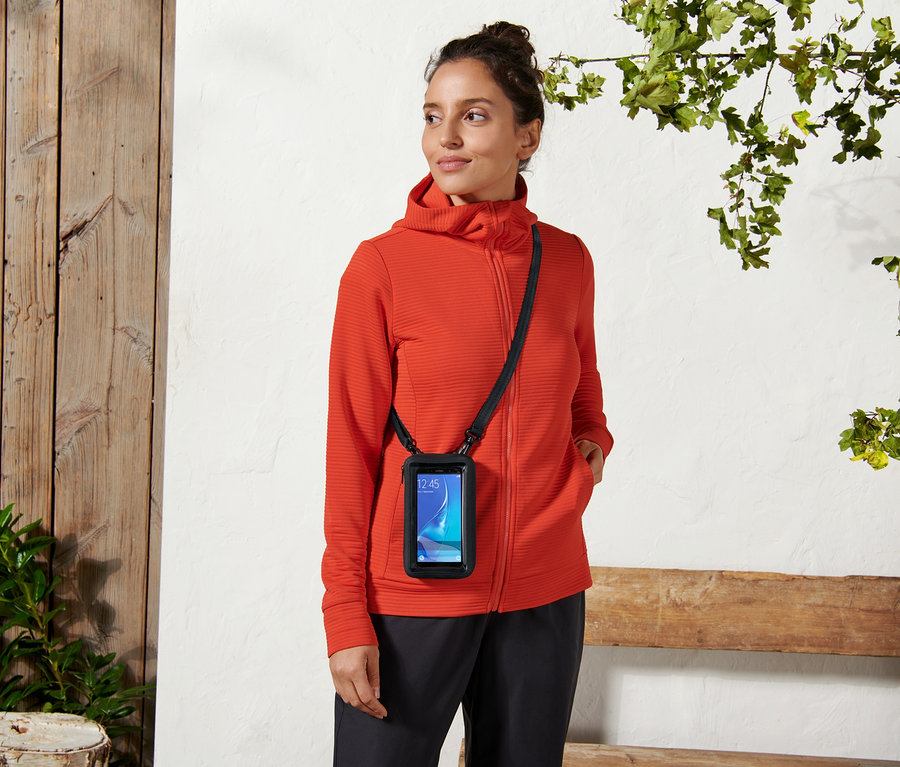 Žena má na sobě taštičku na smartphone 2 v 1.