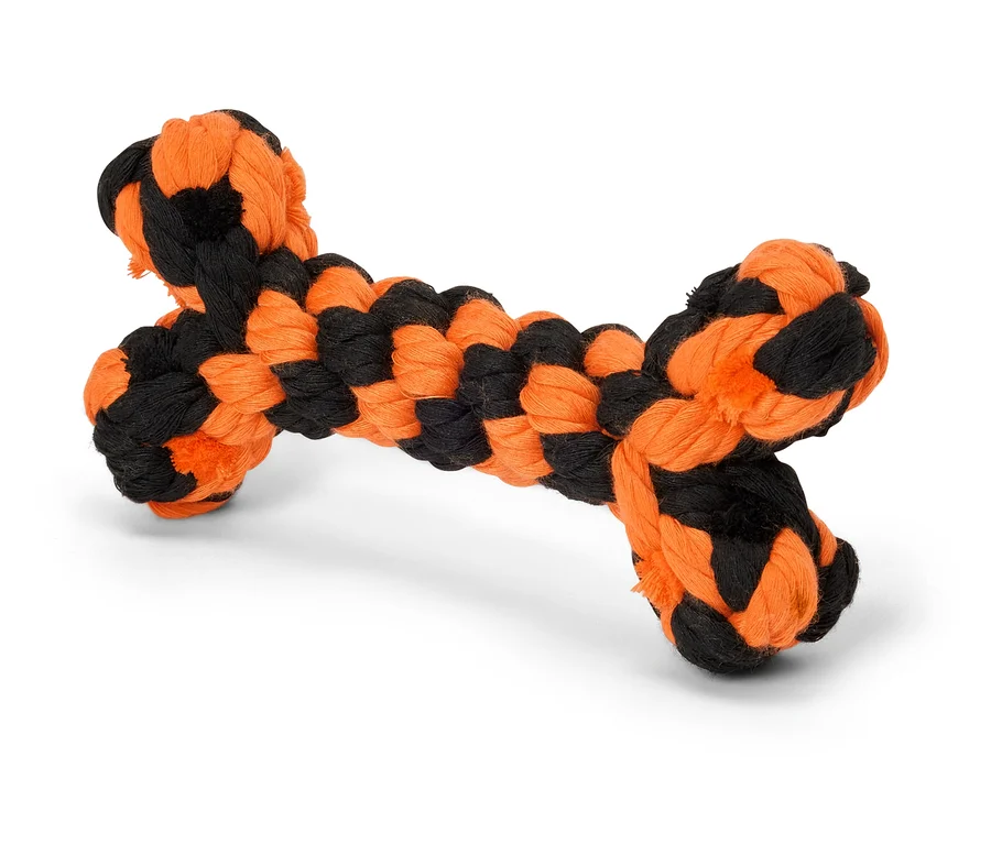 Černo-oranžová hračka pro psy ve tvaru kosti.