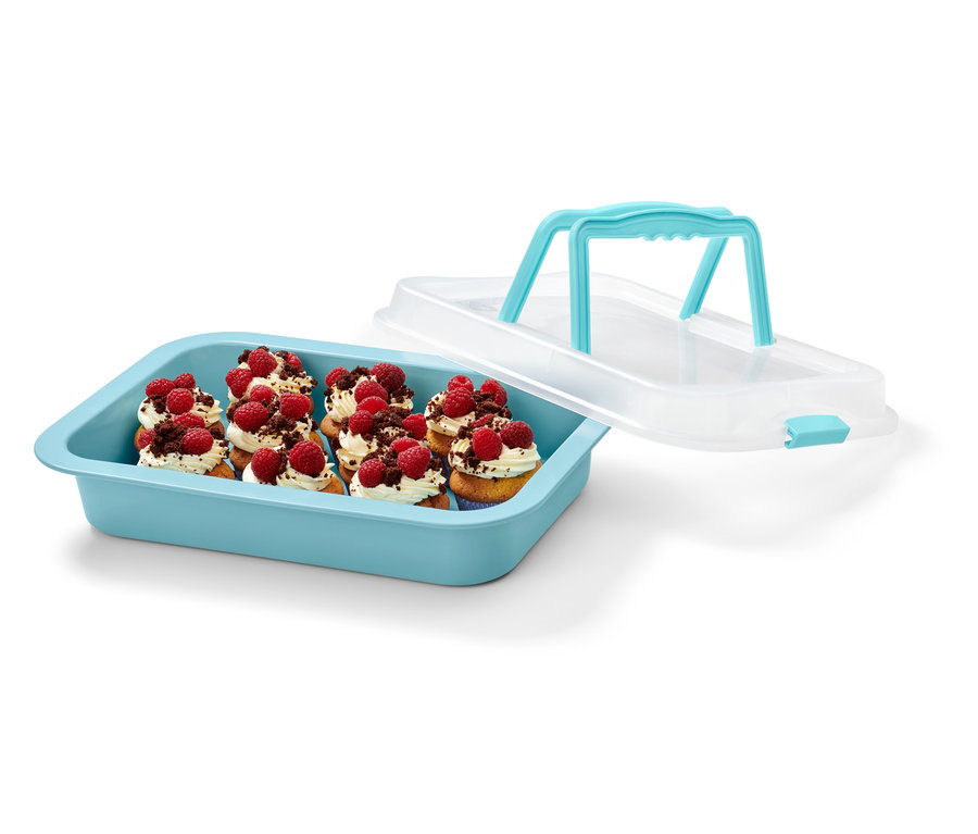 Modrý plech na pečení s víkem a upečené košíčky s malinami.