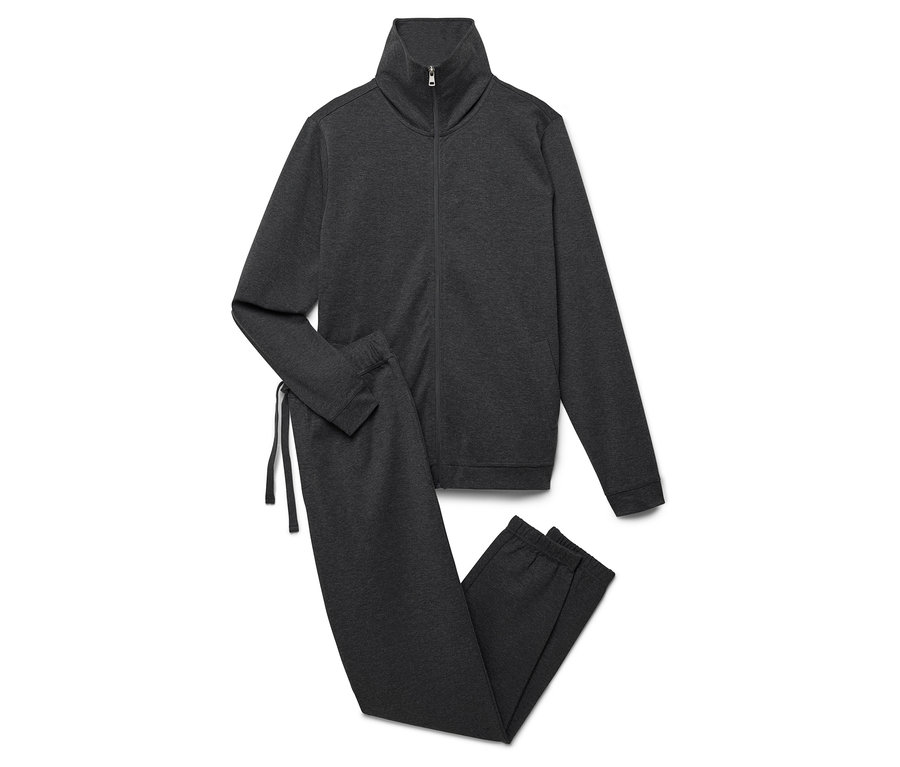 Šedá tepláková souprava s rozepínací bundou a kalhotami leží na bílém pozadí.