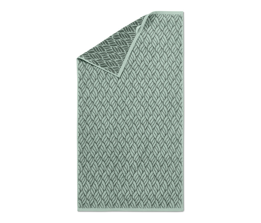 Zelená žakárová osuška se vzorem listů.