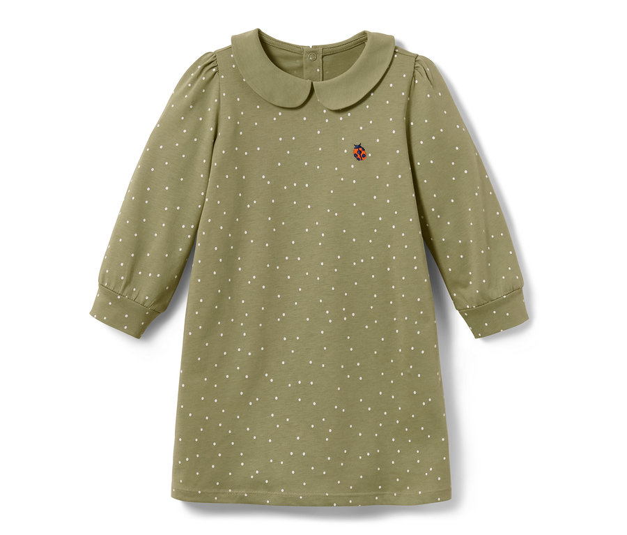 Zelené žerzejové šaty pro malé děti s bílými puntíky a lístečkem.