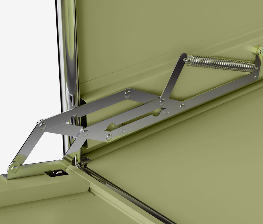 Detail vnitřku otevřené kovové skříně s mechanismem pružinového pantu.