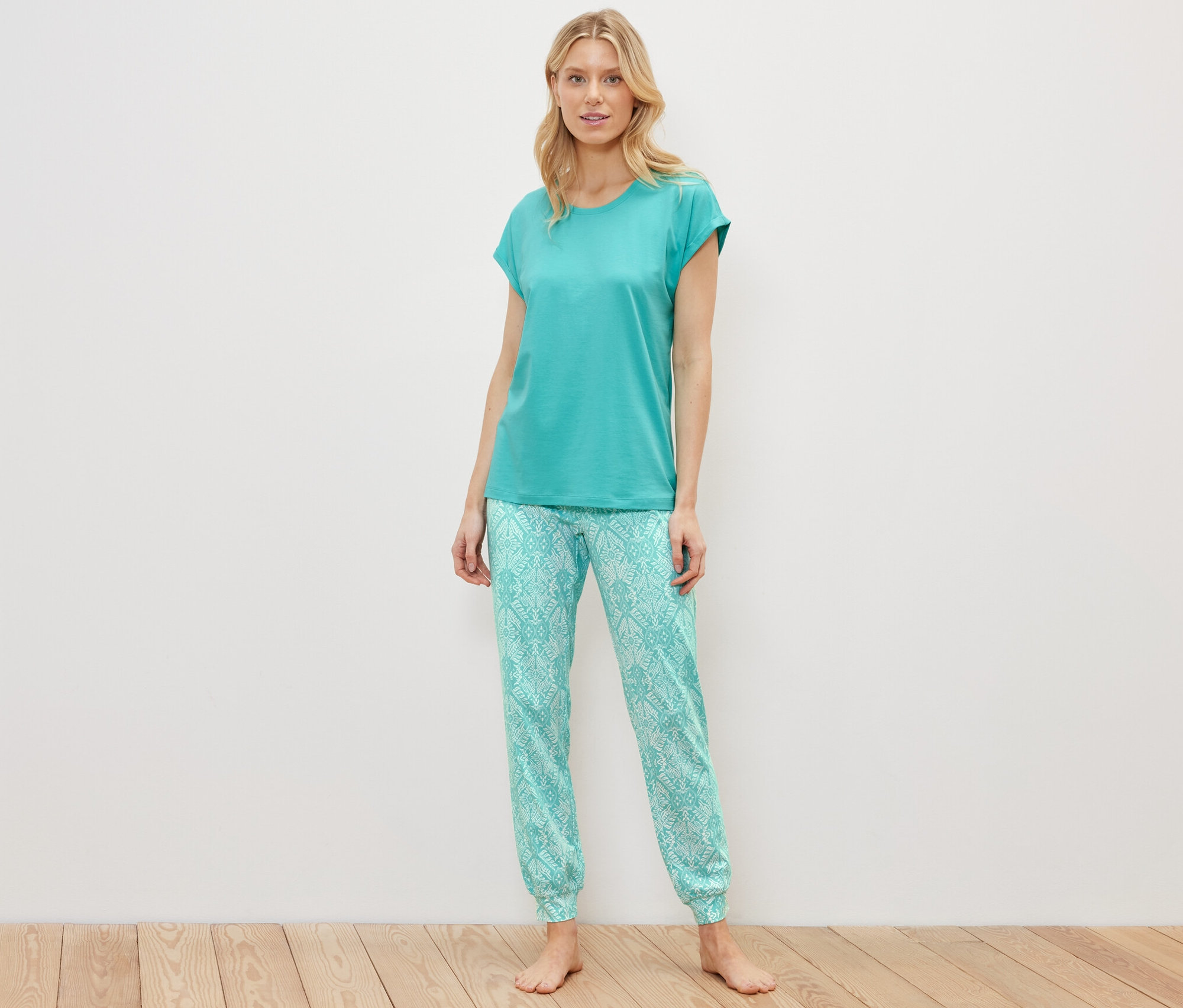 Blondýna stojí a má na sobě pyžamový set.