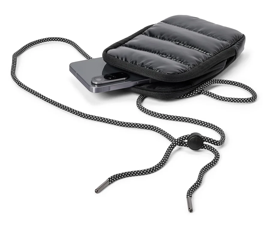 Šedý smartphone je vložen do černého, prošívaného pouzdra na telefon s černo-bílou šňůrkou.