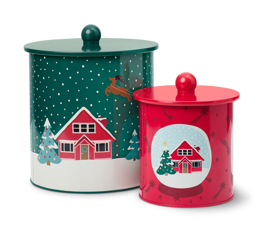 Dvě dózy na cukroví s vánočními motivy domů a stromů.