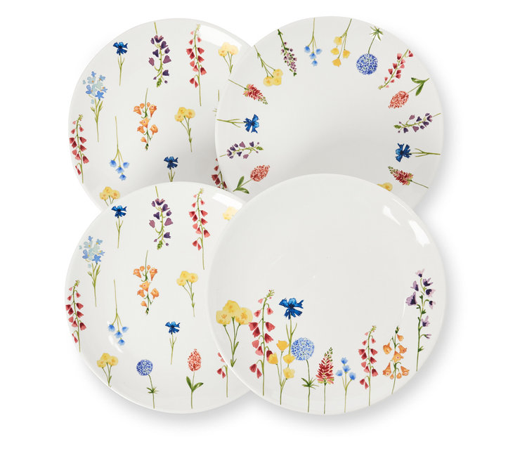 Čtyři dezertní talíře s květinovým dekorem leží na sobě.