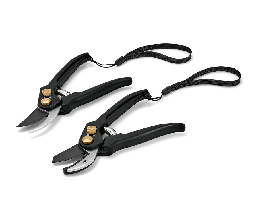Dvoje černé zahradnické nůžky se stříbrnými čepelemi a černými poutky.