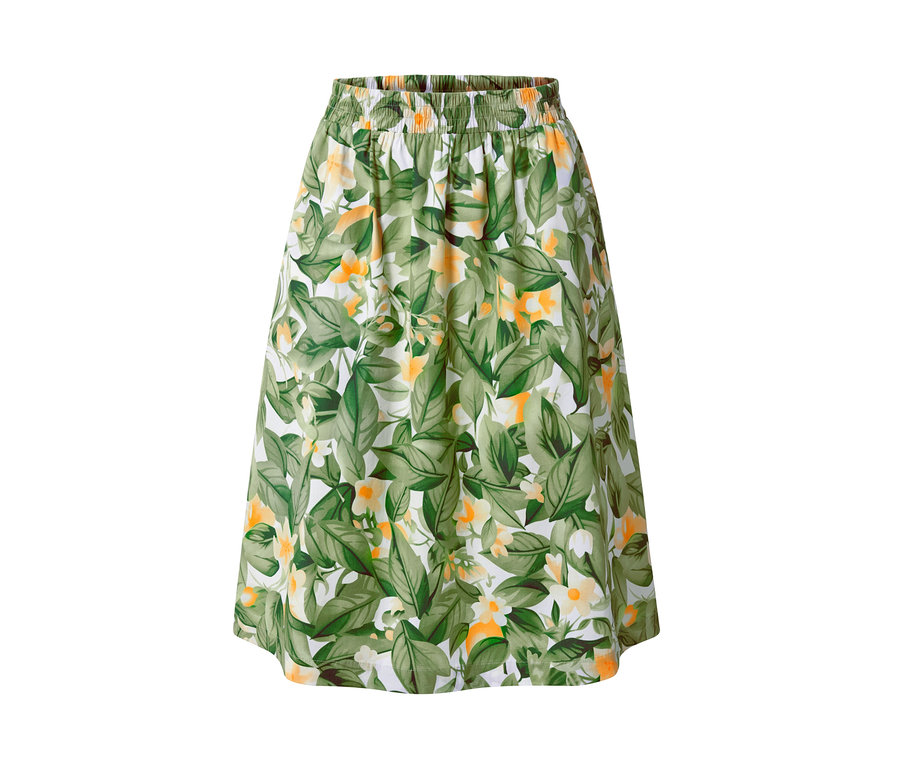 Popelínová sukně s potiskem se zelenými listy a žlutými květy na bílém pozadí.