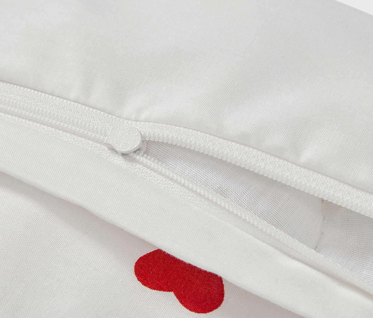 Detail dětského povlečení renforcé, 100 x 135 cm, s červenými srdíčky a zipem.