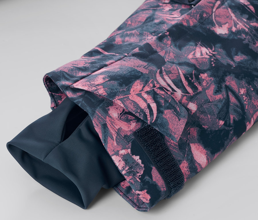 Detail rukávu lyžařské bundy s polovičním zipem a celoplošným potiskem.