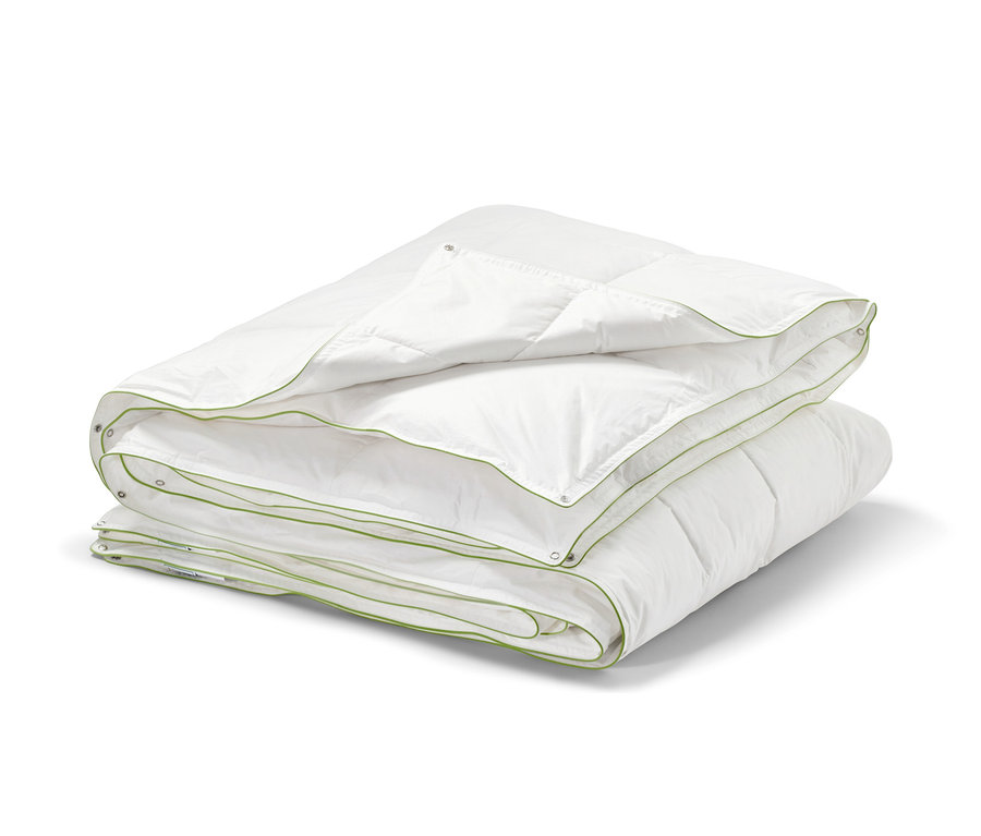 Složená bílá péřová přikrývka irisette® greenline se zeleným lemem.