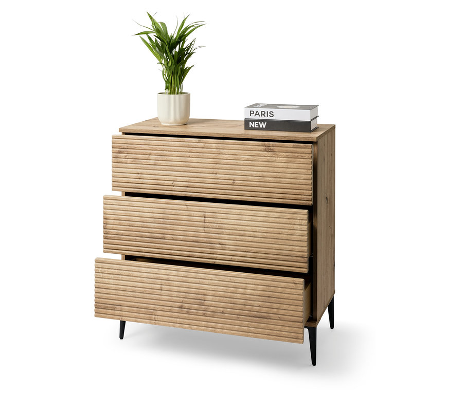 Komoda se třemi zásuvkami a rostlinou v květináči.