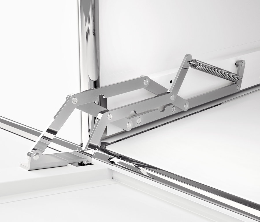 Detail bílé kovové skříňky CN3 s výklopnými dvířky a kovovým mechanismem.