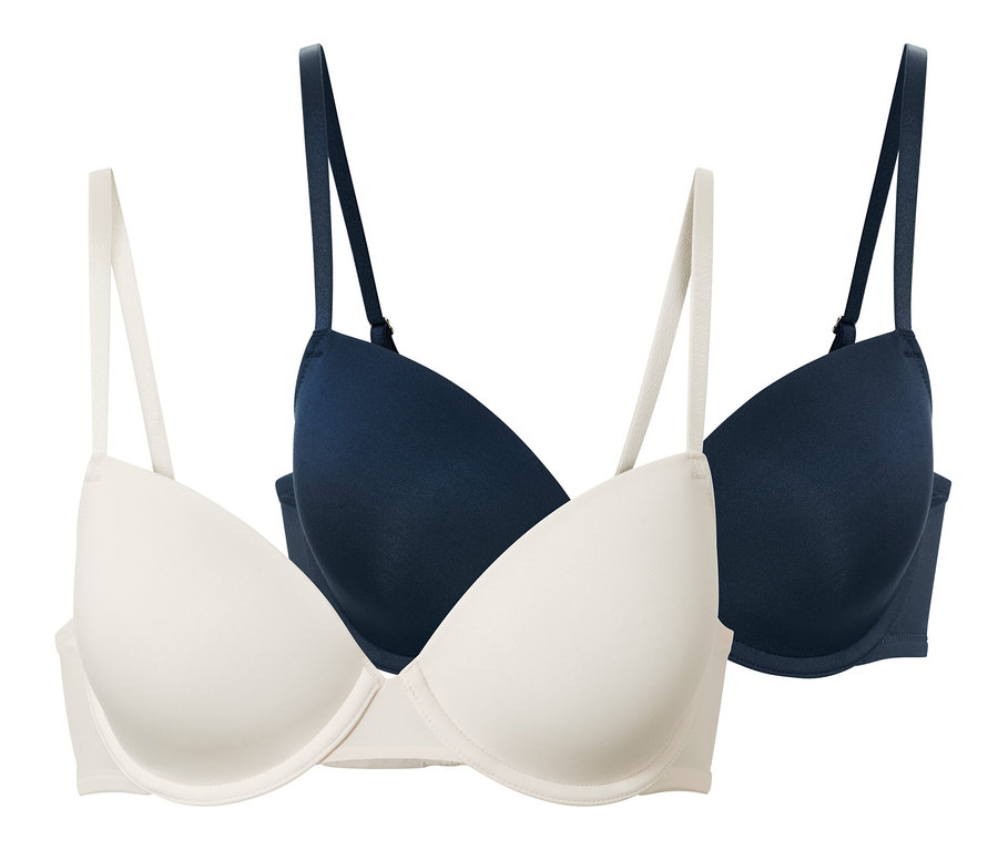 Dvě podprsenky s vyztuženými košíčky v krémové a tmavě modré barvě.