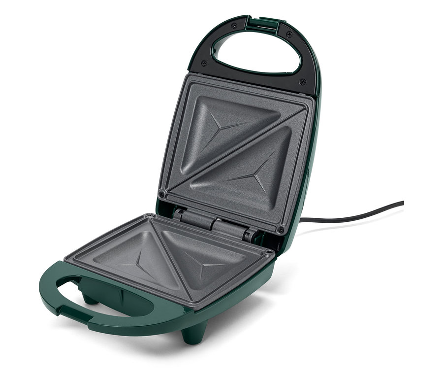 Otevřený zelený sendvičovač s trojúhelníkovými prohlubněmi.