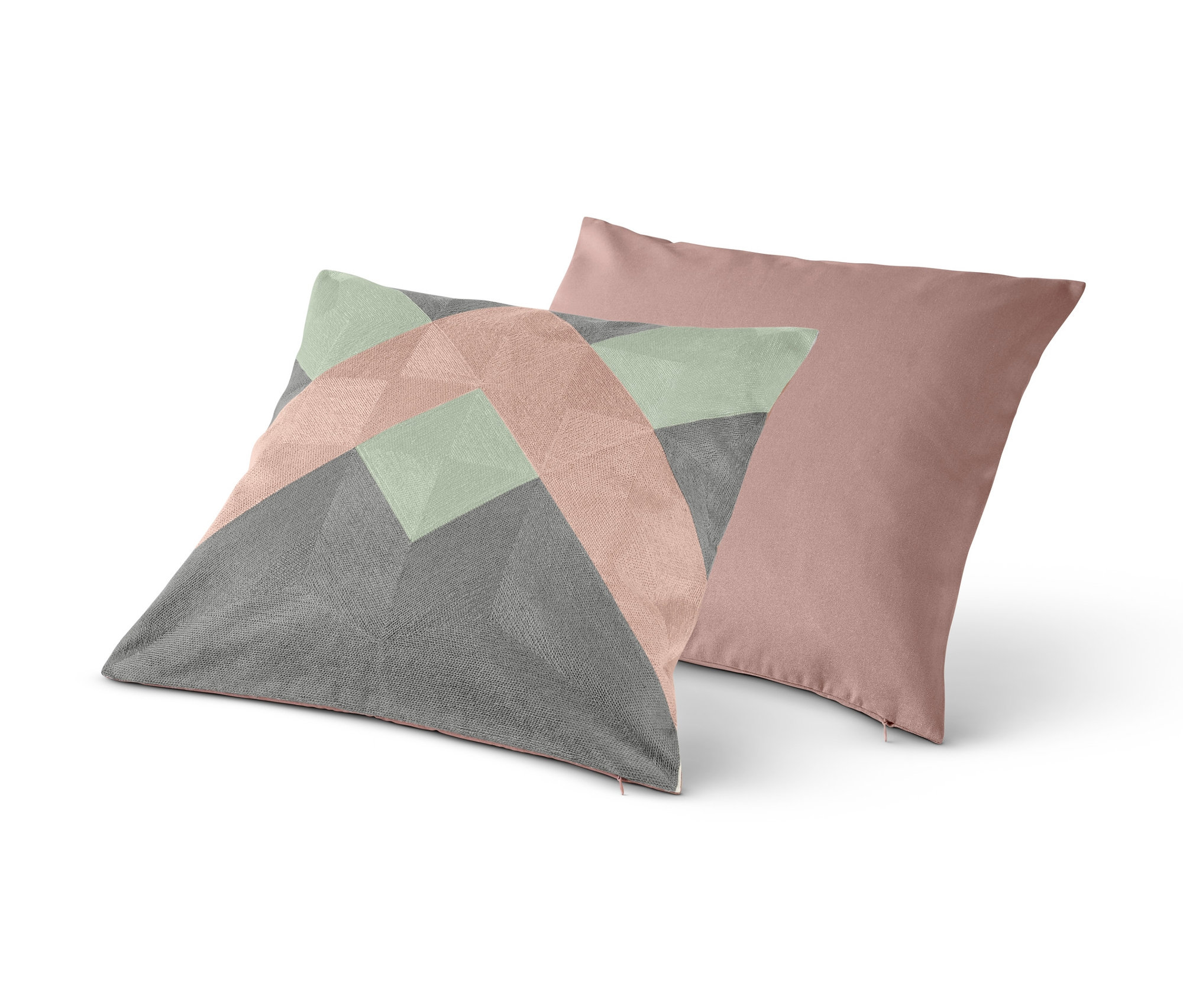 Dva dekorační povlaky na polštáře. Jeden s geometrickým vzorem, druhý růžový.