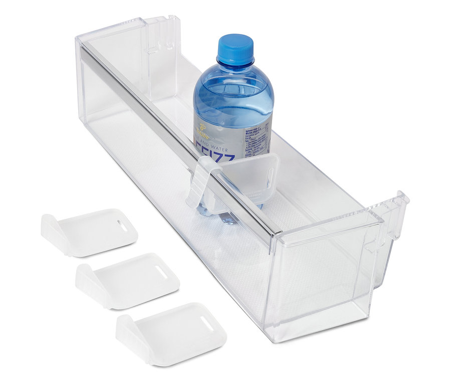 V průhledné zásuvce je láhev s vodou a tři bílé odkládací misky.