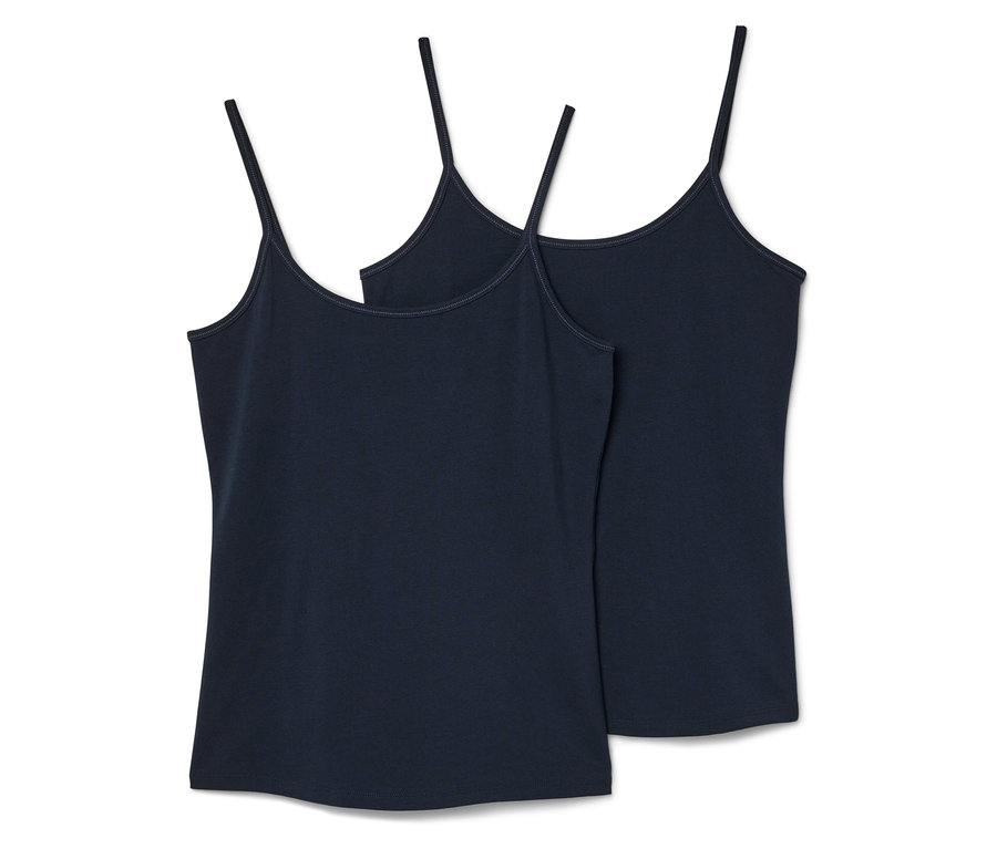 Dvě tílka s tenkými ramínky v tmavě modré barvě, ležící vedle sebe.