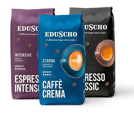 Tři balení zrnkové kávy Eduscho Ochutnávkový set 3kg. Balení jsou fialové, modré a černé.
