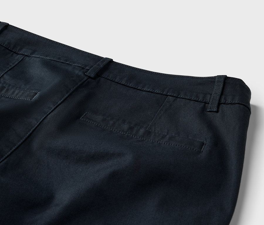 Detail zadní části námořnicky modrých šortek chino.