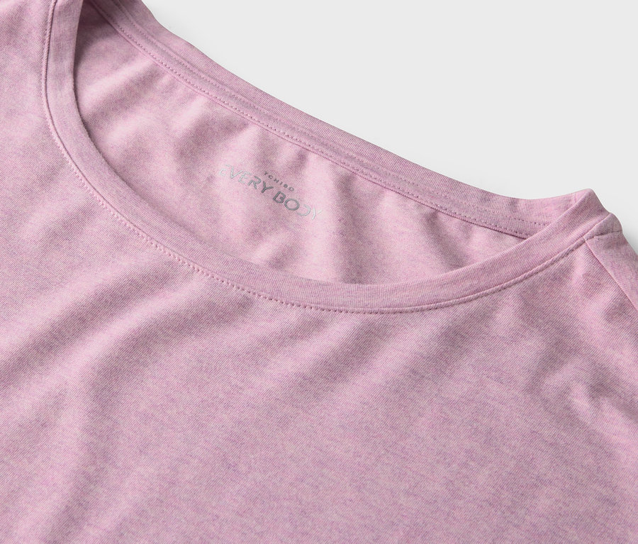Detail růžového trička s kulatým výstřihem.
