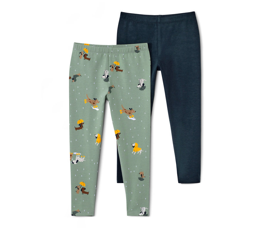 Dvoje dětské legíny: jedny světle zelené s potiskem psů, druhé tmavě modré.