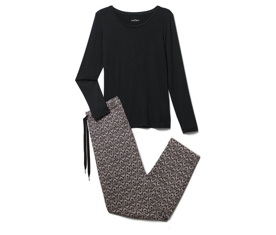 Černé pyžamo s dlouhým rukávem a květinové kalhoty leží na bílém pozadí.