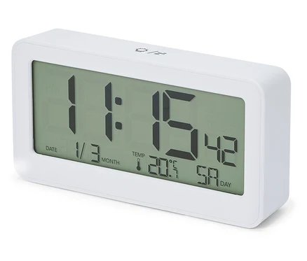 Bílý rádiový LCD budík s digitálním displejem zobrazujícím čas 11:15, datum 1/3 a teplotu 20,5°C.