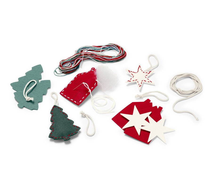Sada na výrobu girlandy s plstěnými přívěsky obsahuje plstěné tvary stromků, hvězd a domků, barevné provázky a výplň.