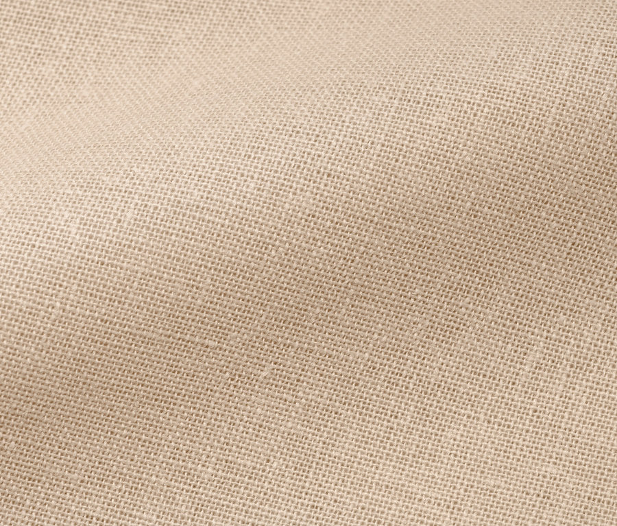 Detailní záběr béžové lněné textilie.