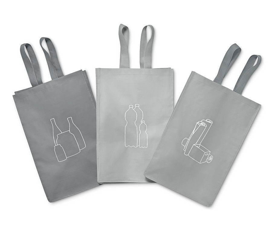 Tři šedé tašky na tříděný odpad s obrázky skla, plastových lahví a baterií.