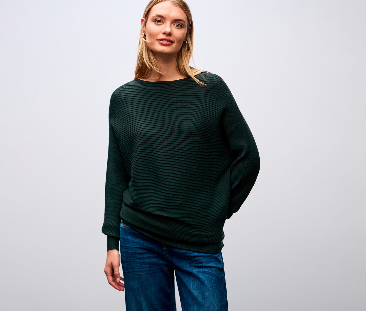 Žena má na sobě strukturovaný svetr Street One a džíny.