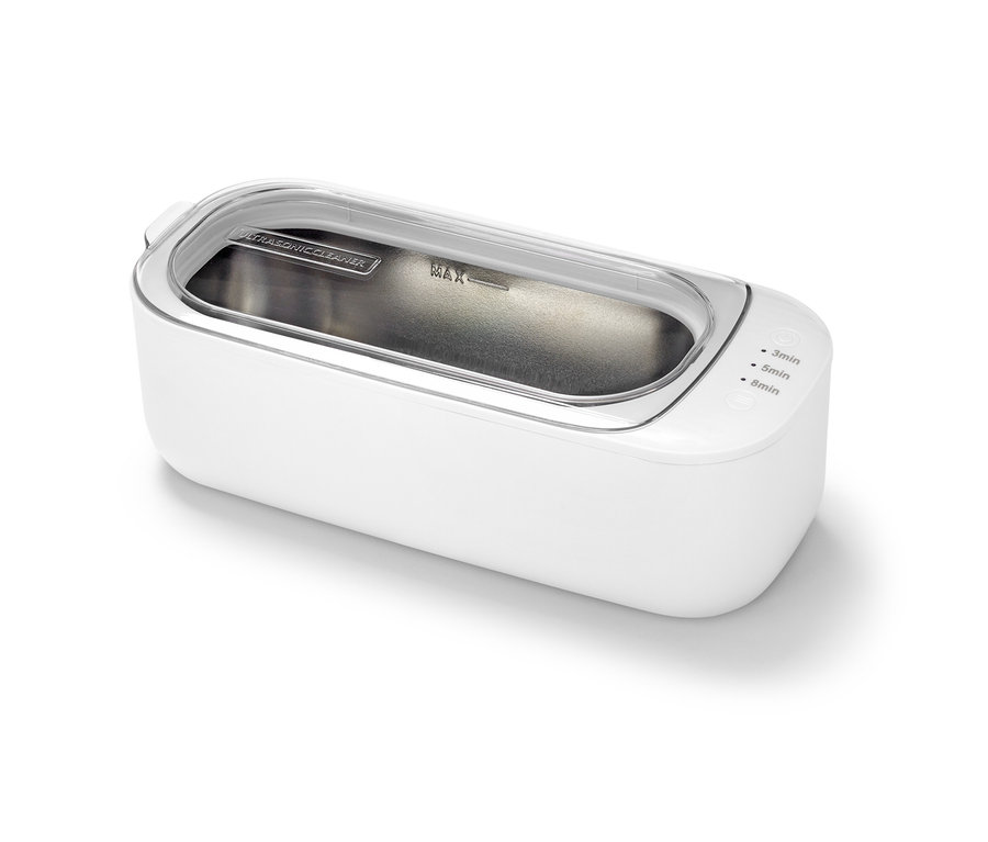 Bílý ultrazvukový čistič s průhledným víkem.