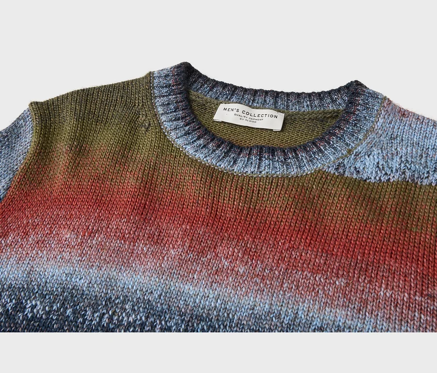 Pletený pánský ombré svetr, přecházející z olivově zelené do červené, poté světle a tmavě modré. Štítek "MEN'S COLLECTION by TCHIBO" na límci.