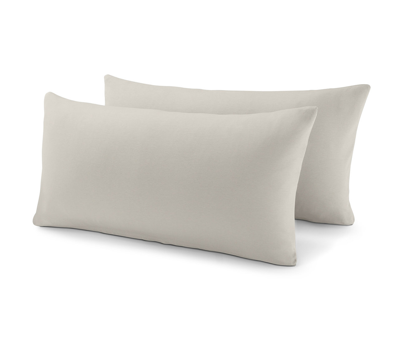 Dva béžové žerzejové povlaky na polštáře, každý cca 80 x 40 cm, leží vedle sebe.