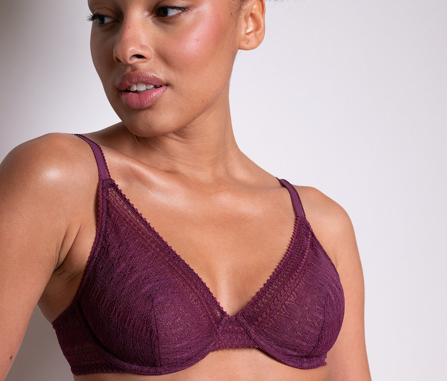Žena má na sobě fialovou podprsenku s kosticemi Passionata »Leila«.