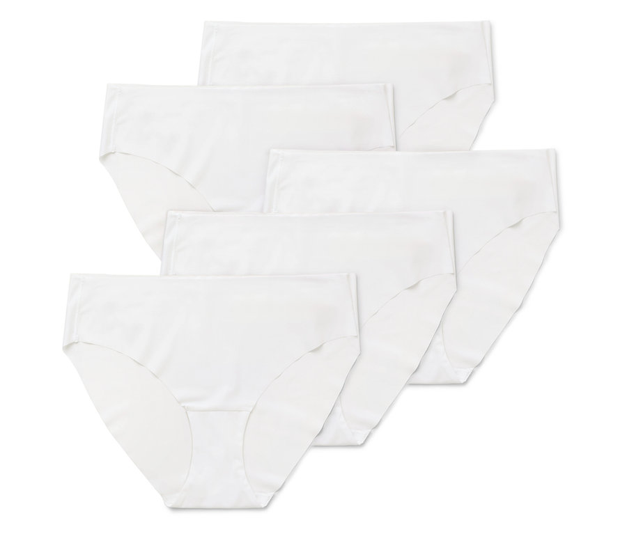 Několik párů bílých dámských kalhotek naskládaných na sobě.