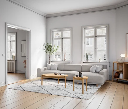 Obývací pokoj s komodou a designovou stolní LED lampou na dřevěném stolku vedle pohovky.