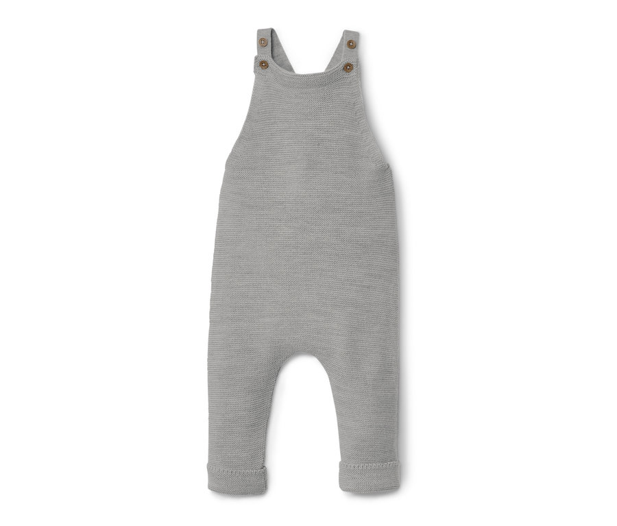 Šedé kalhoty s laclem z vlny merino pro miminka leží na bílém pozadí.