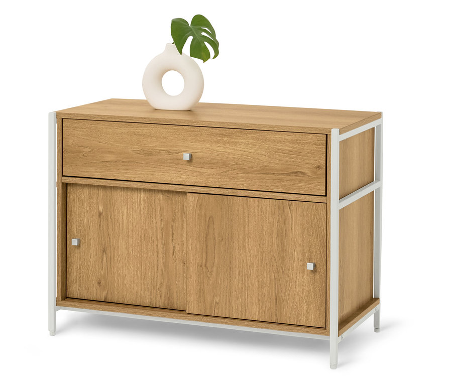 Komoda ze světlého dřeva s bílými kovovými nohami, na které je bílá váza se zeleným listem.