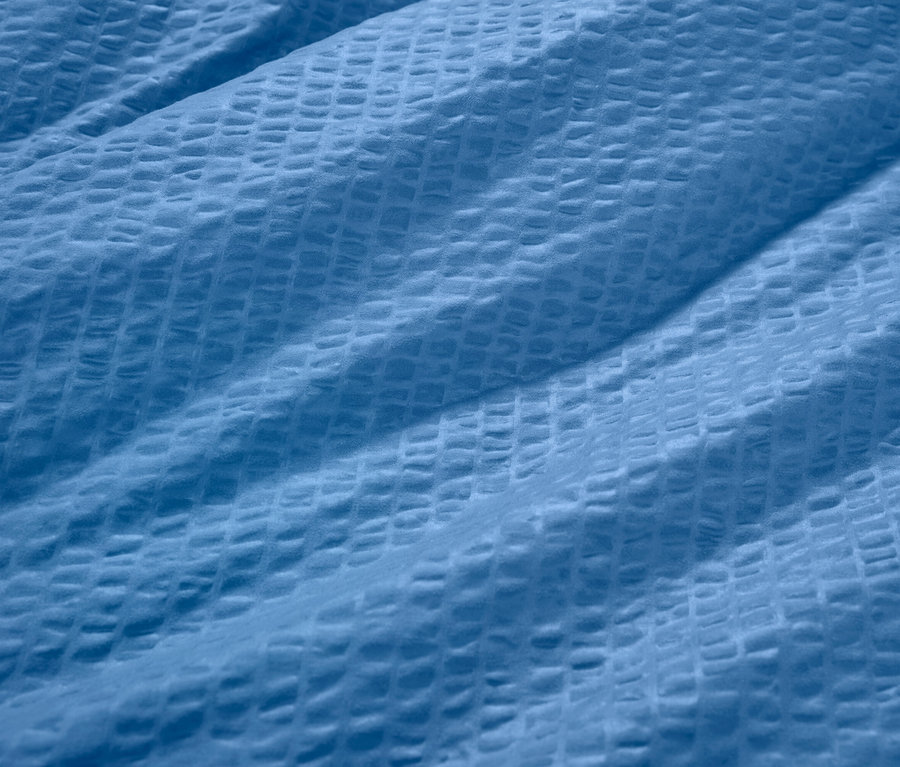 Detail modrého krepového povlečení.