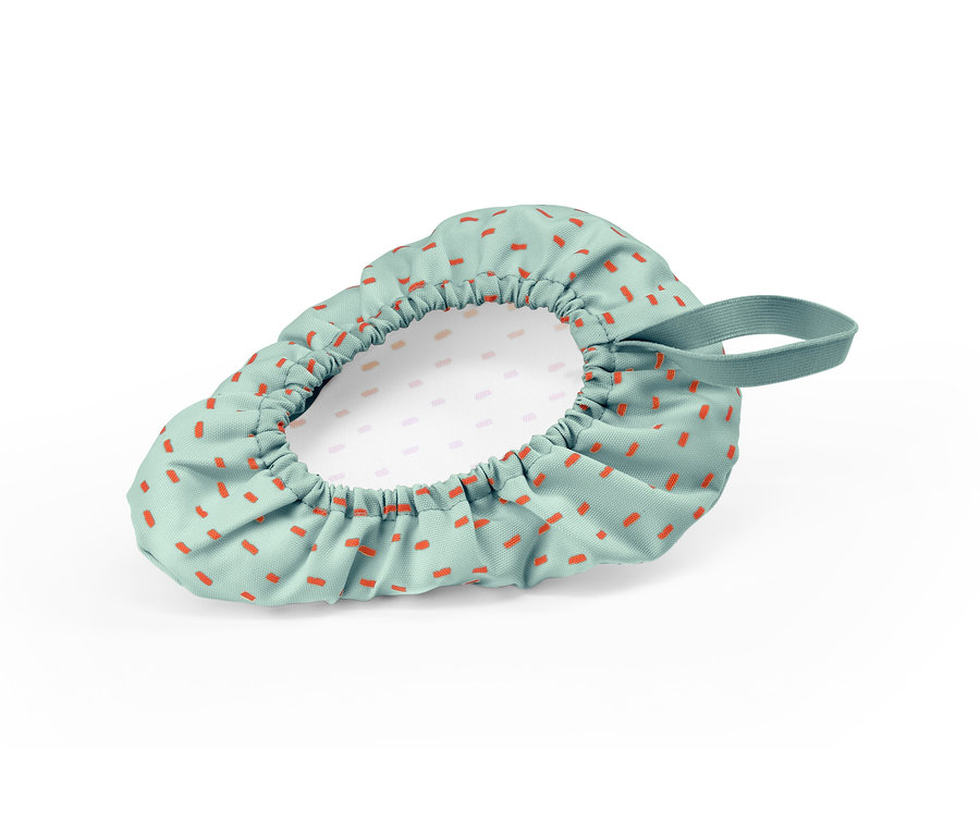 Dětský potah na cyklistické sedlo s oranžovými obdélníky na zeleném pozadí.