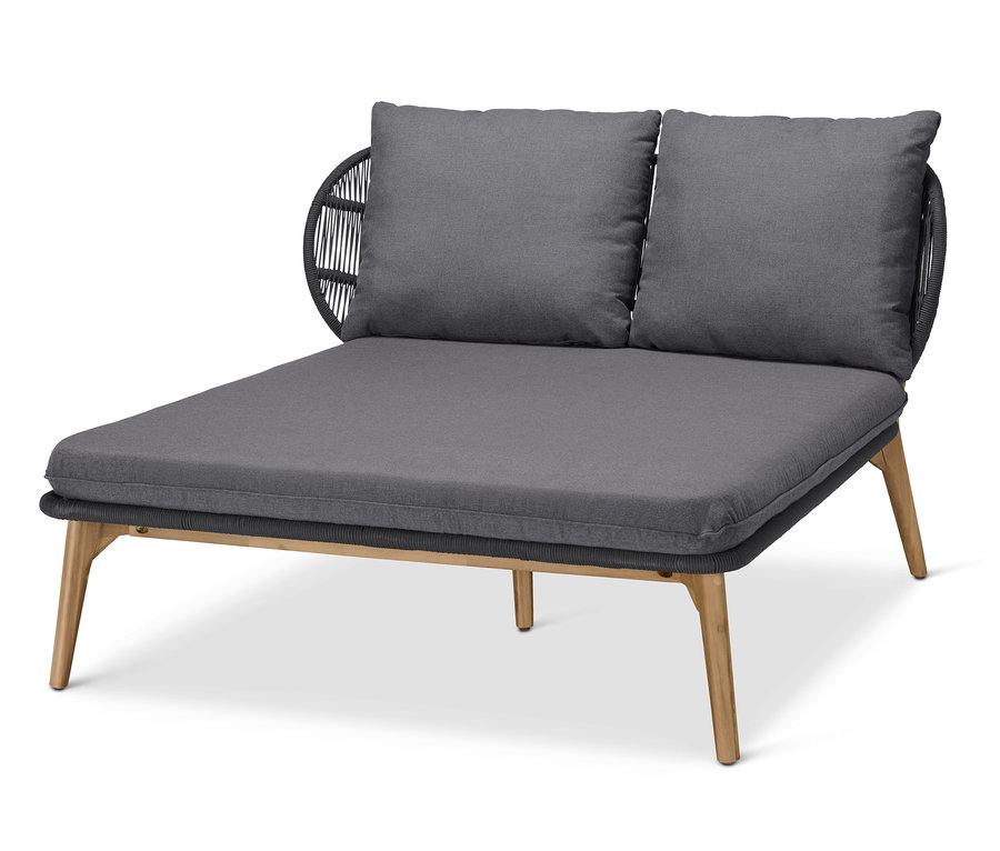 Šedá pohovka na denní spaní s podhlavníkem a textilním výpletem.