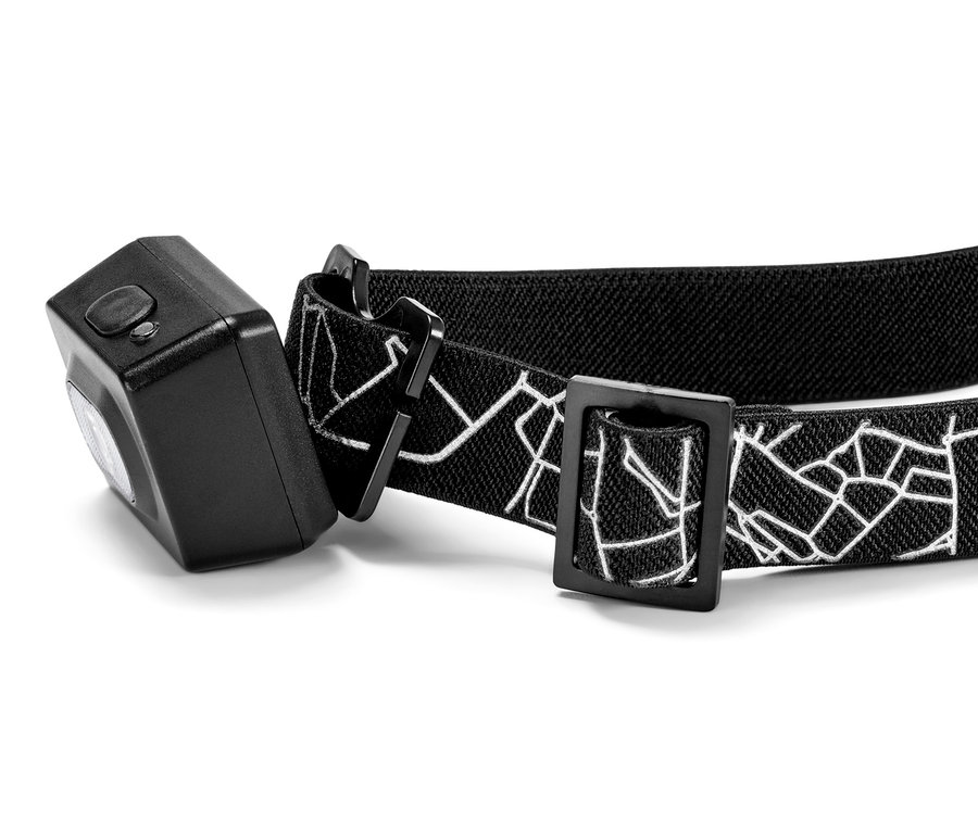 Čelovka s černým elastickým popruhem s bílým geometrickým vzorem.